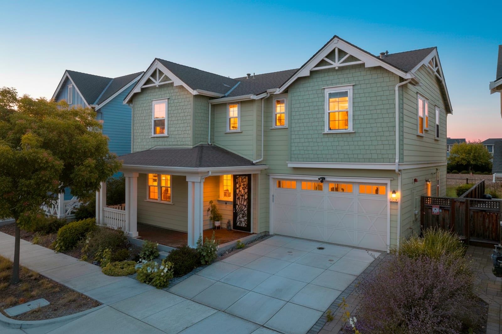 Virtual twilight exterior of a Fremont home with warm glowing windows at dusk