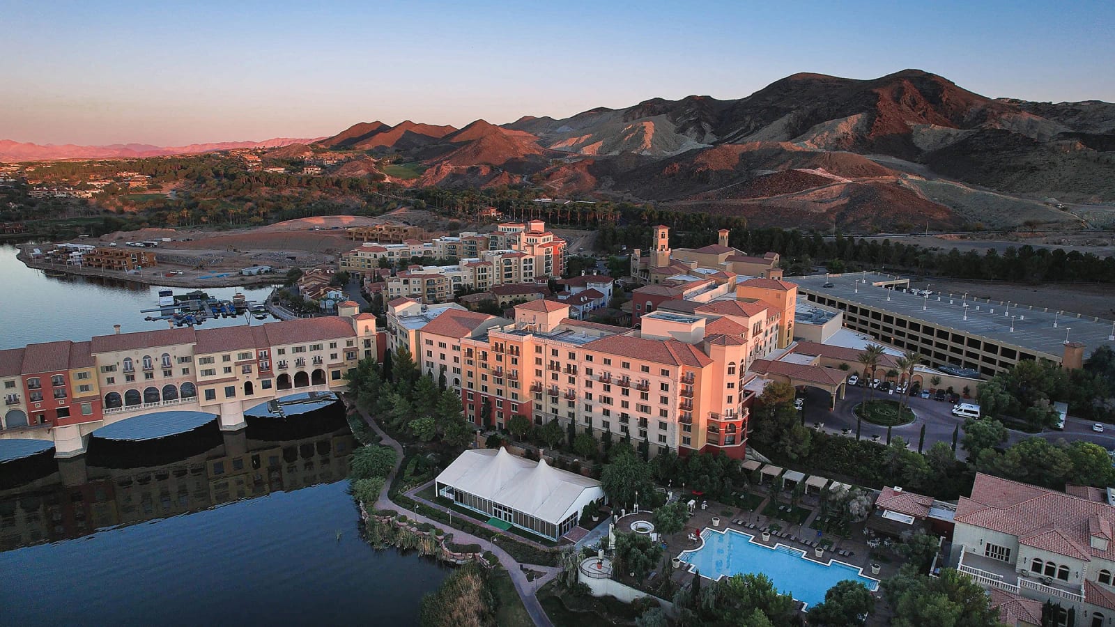 Aerial view of the Hilton Lake Las Vegas Resort and Spa at sunset with desert mountains beyond
