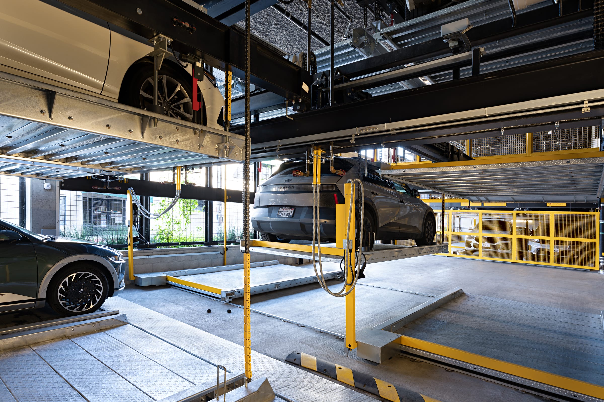 Parkworks automated parking system at Felix Apartments: a raised pallet holding a car above the drive aisle